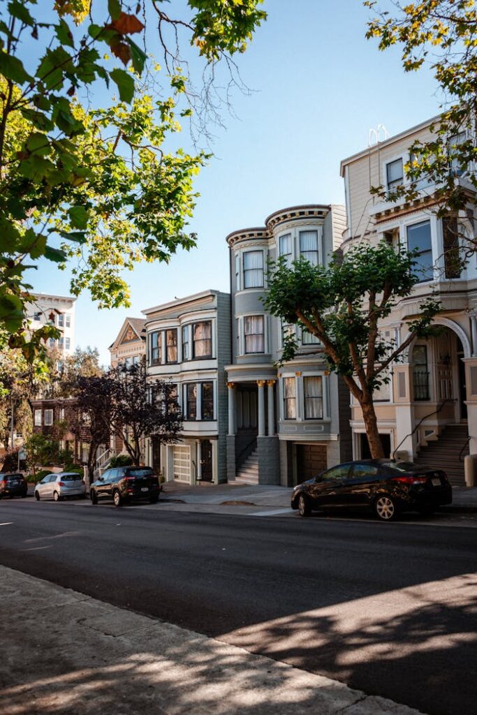 pexels-photo-6039192 Various cars parked on asphalt road near classic styled residential houses against cloudless blue sky in San Francisco